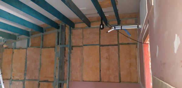 Ceiling beams up and insulation underway.jpg